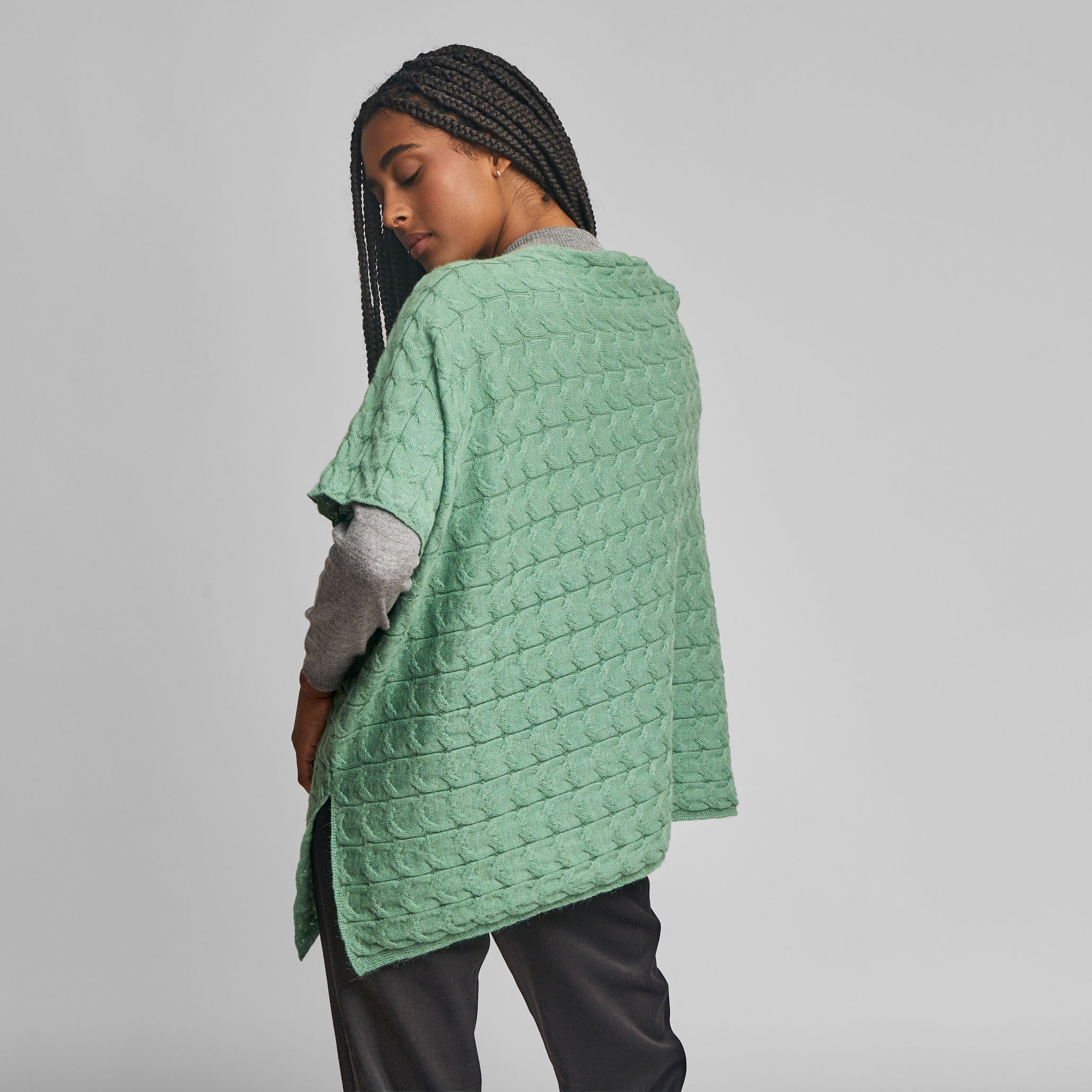 Women’s green Baby Alpaca poncho styled over a grey sweater