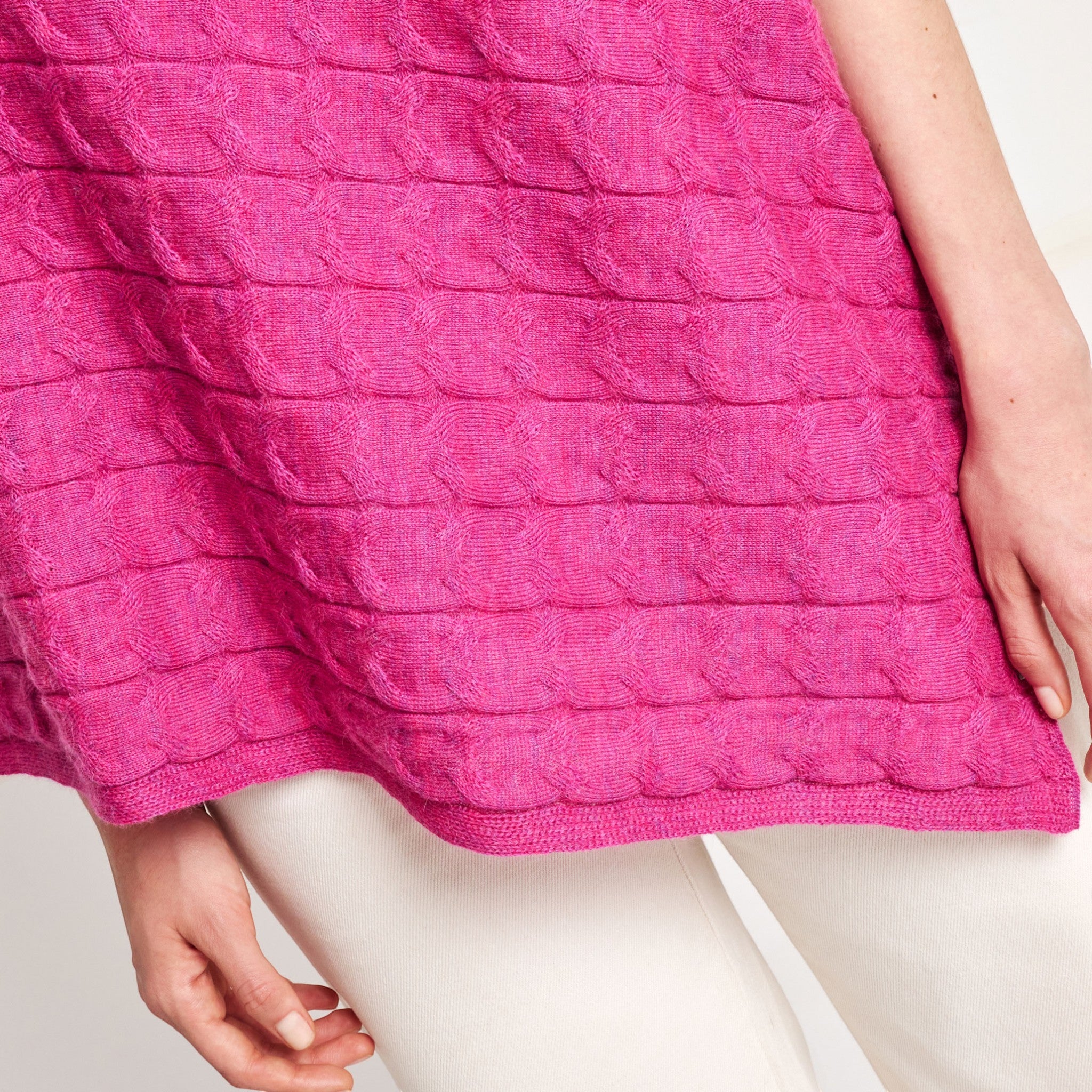 Soft textured Willow Poncho in vibrant pink on a female model