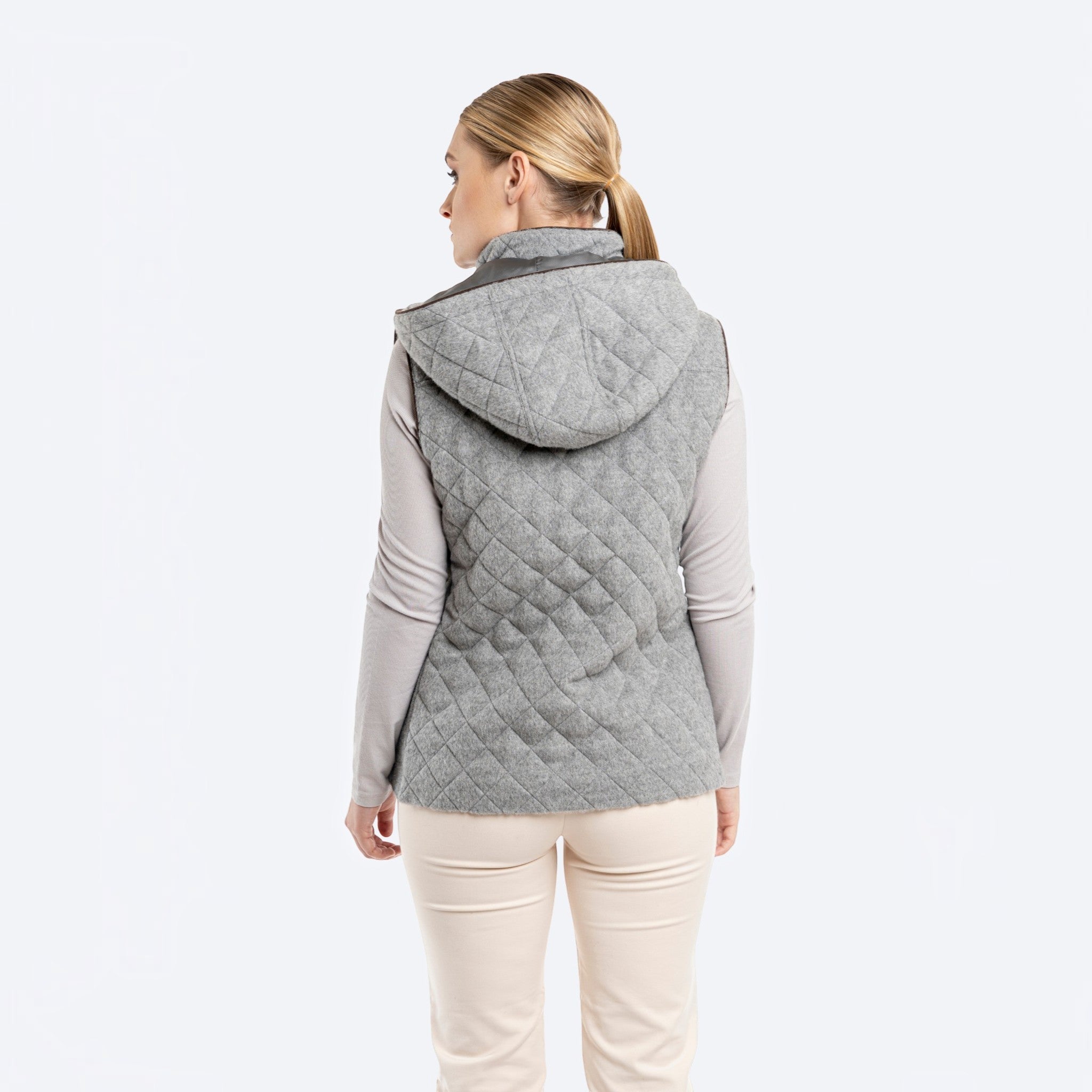 Silver alpaca wool vest shown from the back with channel quilting and detachable hood