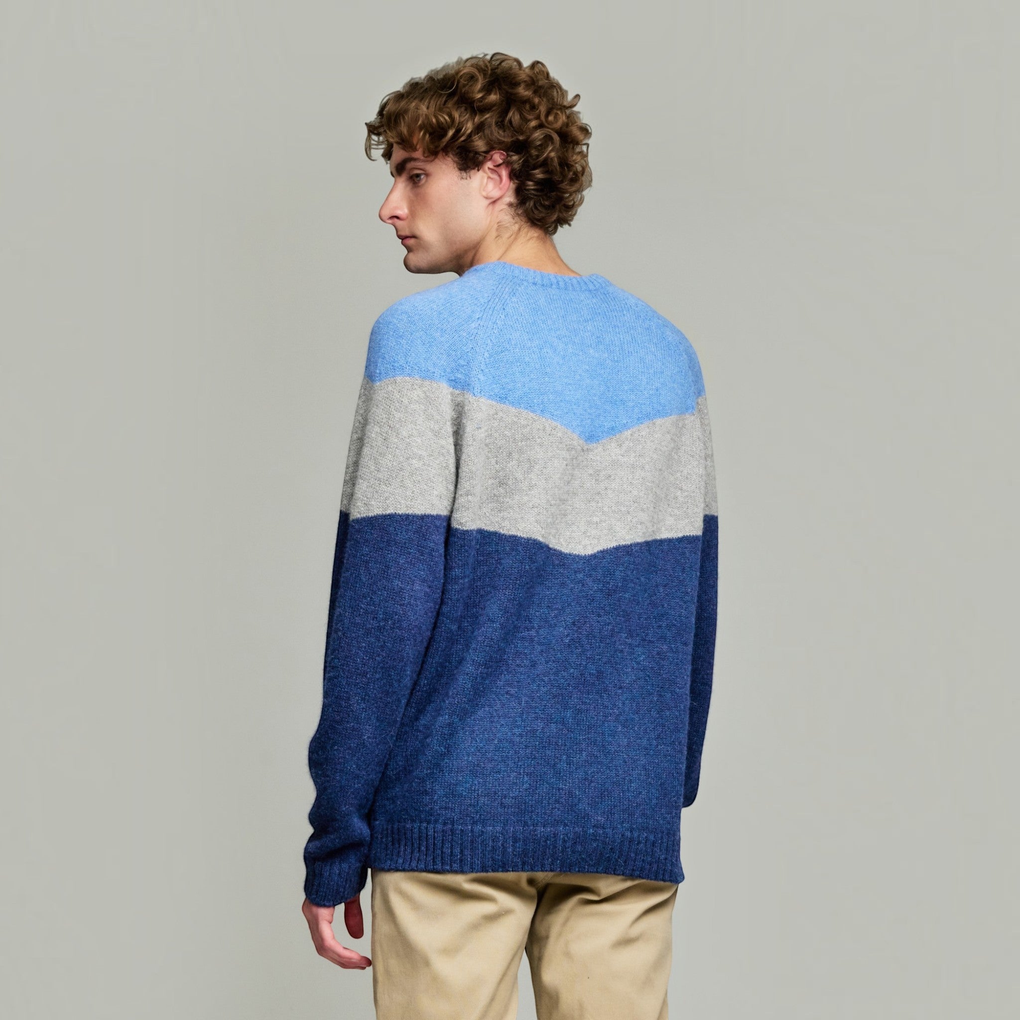 Back view of men’s blue and grey Baby Alpaca colour-block sweater