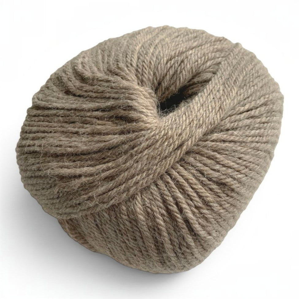 Ball of 100% baby alpaca sport weight yarn in soft natural taupe.