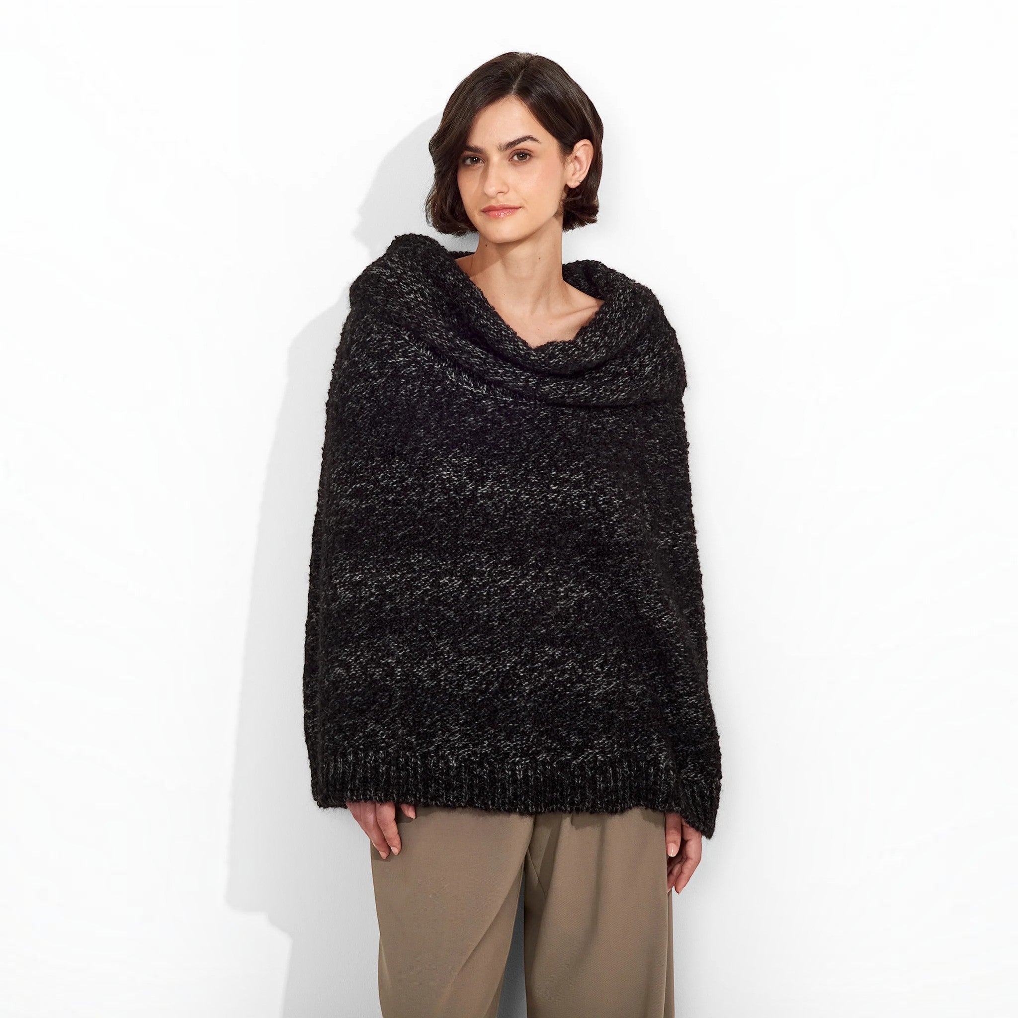 Front view of the black Zaira alpaca blend poncho with a soft textured knit and draped neckline