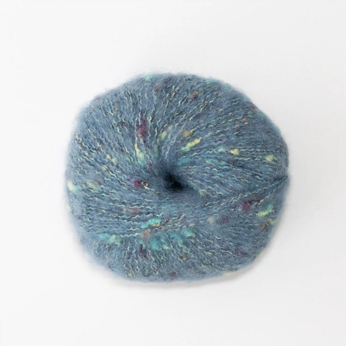 Overhead view of Aqua Indulge baby alpaca bouclé yarn without a label.