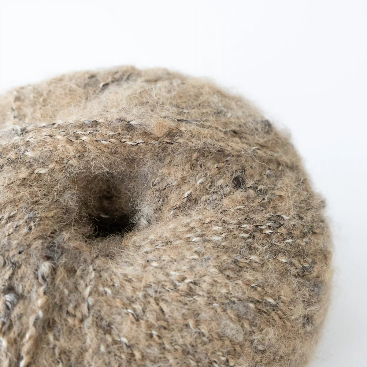 Close-up of Camel Indulge baby alpaca bouclé yarn showing its looped texture.