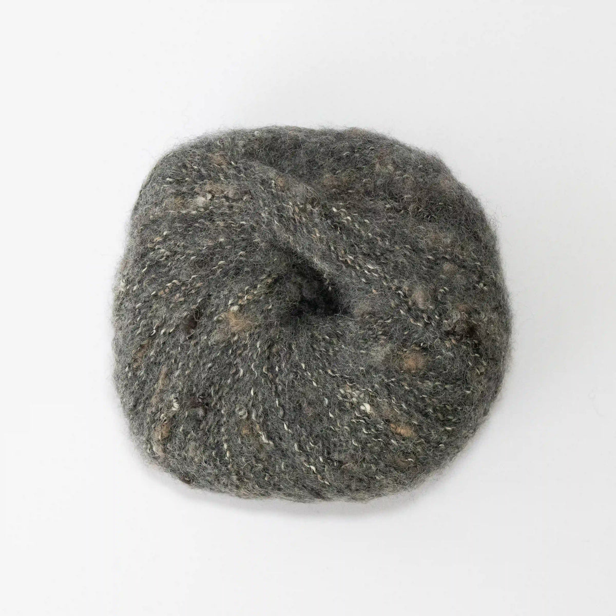 Overhead view of Charcoal Indulge baby alpaca bouclé yarn without a label.