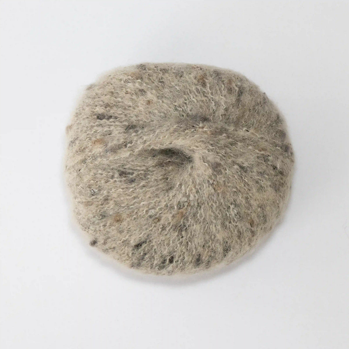 Overhead view of Nougat Indulge baby alpaca bouclé yarn without a label.