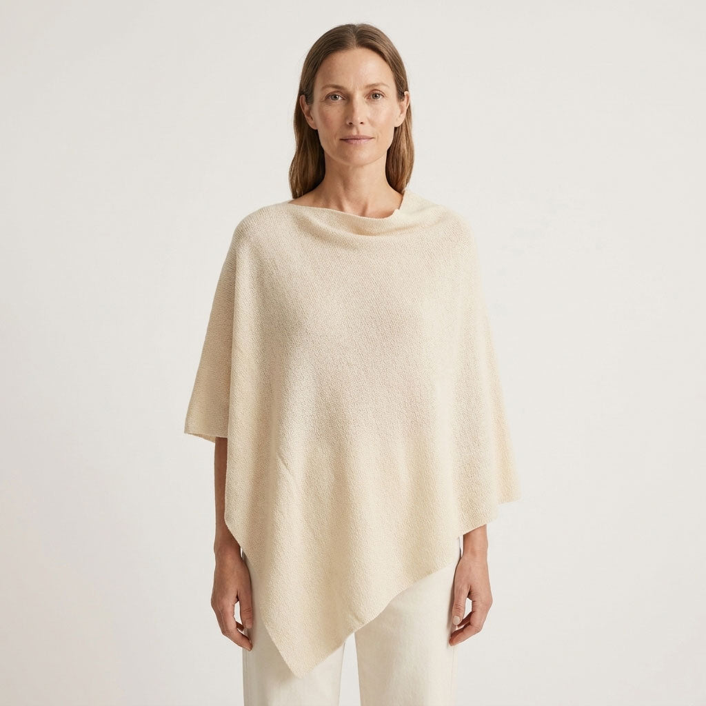 Sorpresa alpaca poncho in Ecru, a soft natural cream shade, shown on a female model