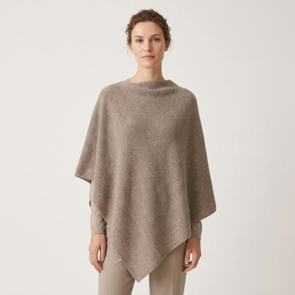 Sorpresa alpaca poncho in Fawn, a soft neutral beige shade, shown on a female model